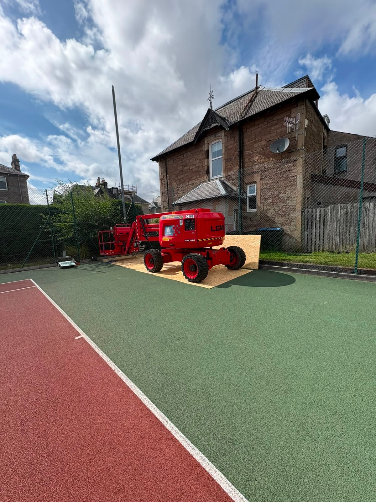 Mobile lift beside a floodlight column during the Perth Tennis Club upgrade